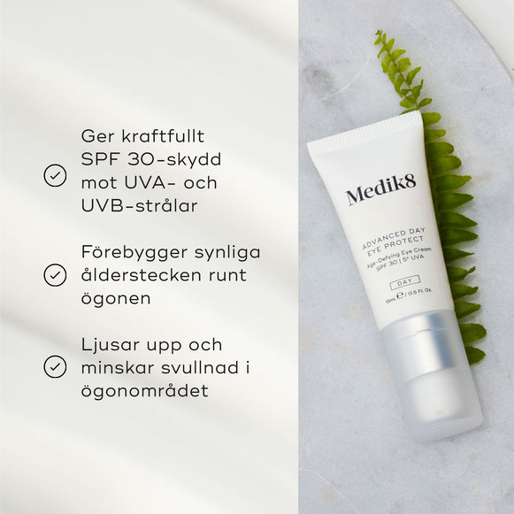 Advanced Day Eye Protect ögonkräm från Medik8 liggande på en ljus yta bredvid ett ormbunksblad, med text om produktens fördelar som solskydd och anti-aging.-hover-16